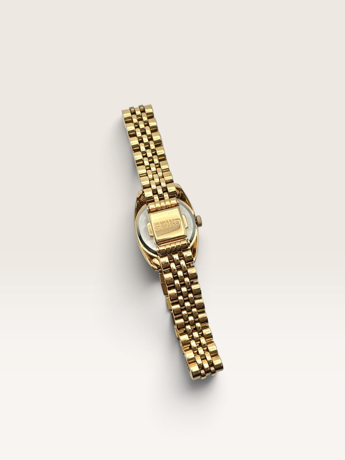 A distinctive vintage Seiko watch featuring a softly rounded gold-tone case