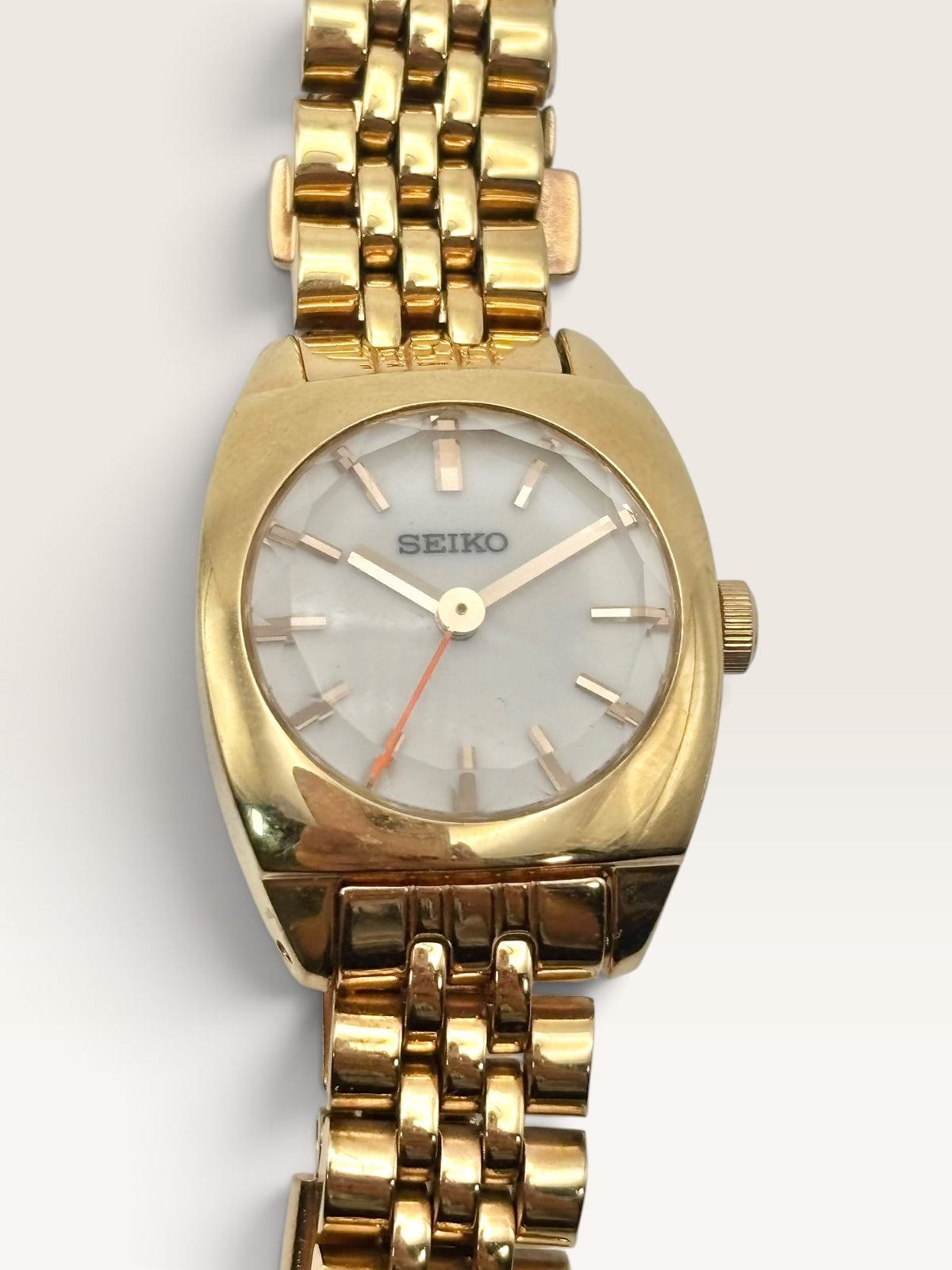 A distinctive vintage Seiko watch featuring a softly rounded gold-tone case