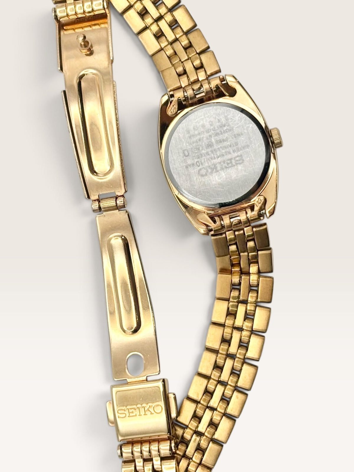 A distinctive vintage Seiko watch featuring a softly rounded gold-tone case