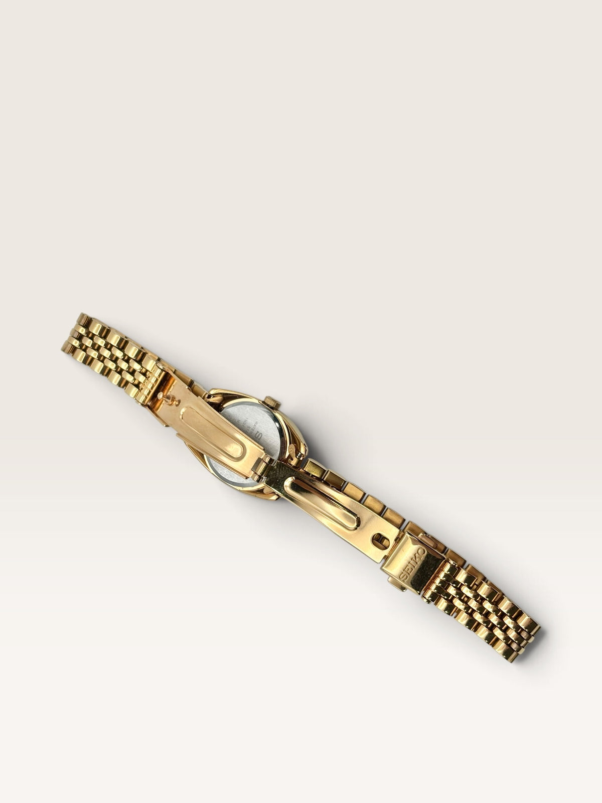A distinctive vintage Seiko watch featuring a softly rounded gold-tone case