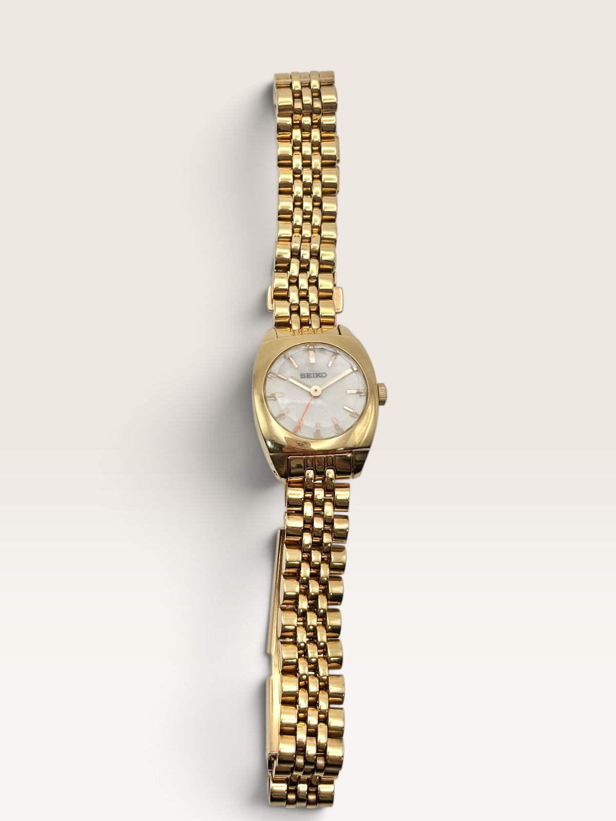 A distinctive vintage Seiko watch featuring a softly rounded gold-tone case