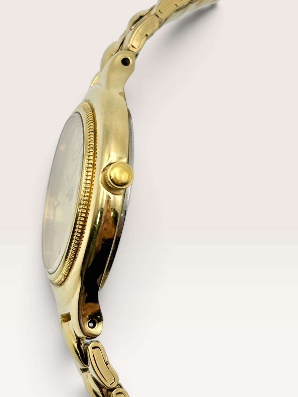 A vintage Seiko watch featuring a rounded gold-tone case