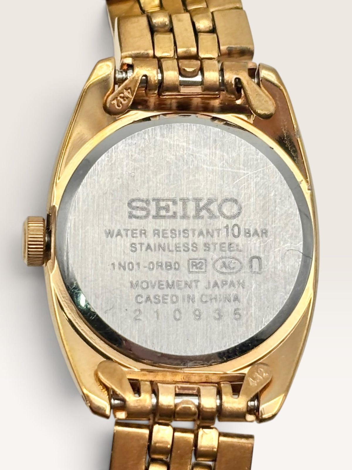 A distinctive vintage Seiko watch featuring a softly rounded gold-tone case