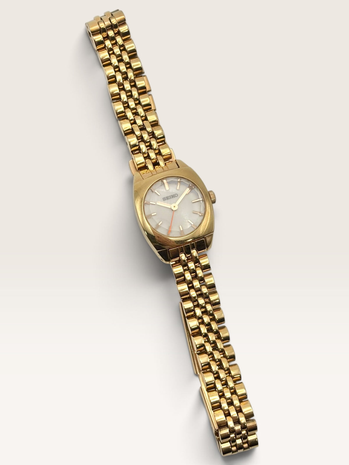A distinctive vintage Seiko watch featuring a softly rounded gold-tone case
