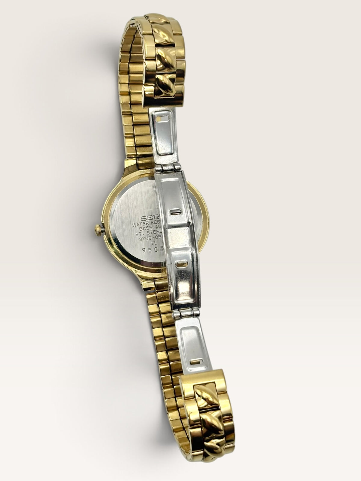 A vintage Seiko watch featuring a rounded gold-tone case