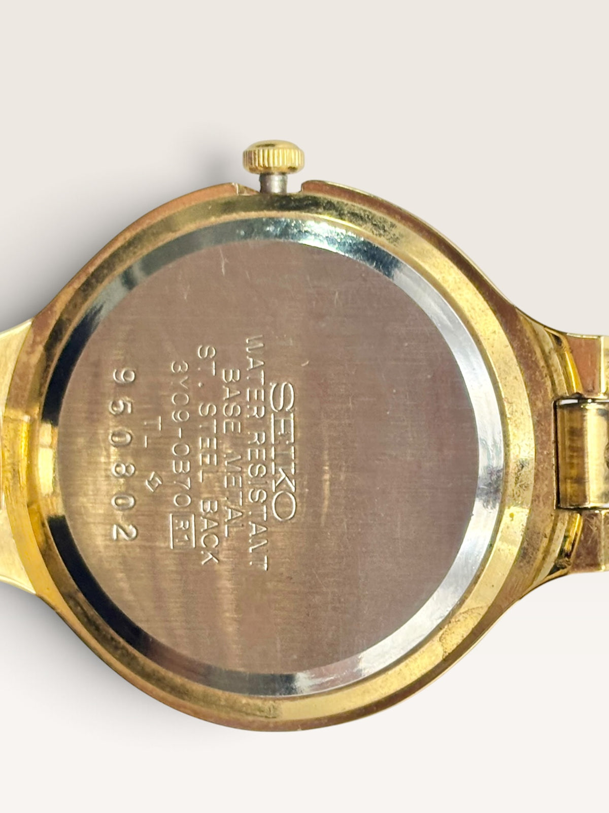 A vintage Seiko watch featuring a rounded gold-tone case