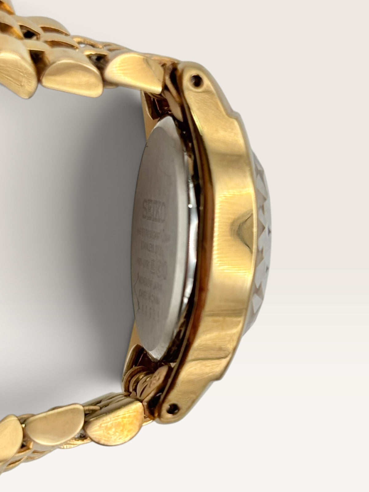 A distinctive vintage Seiko watch featuring a softly rounded gold-tone case